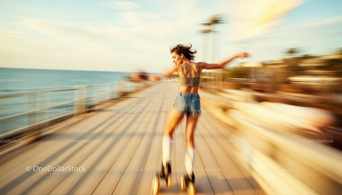 Woman Roller Skating on Boardwalk at Sunset