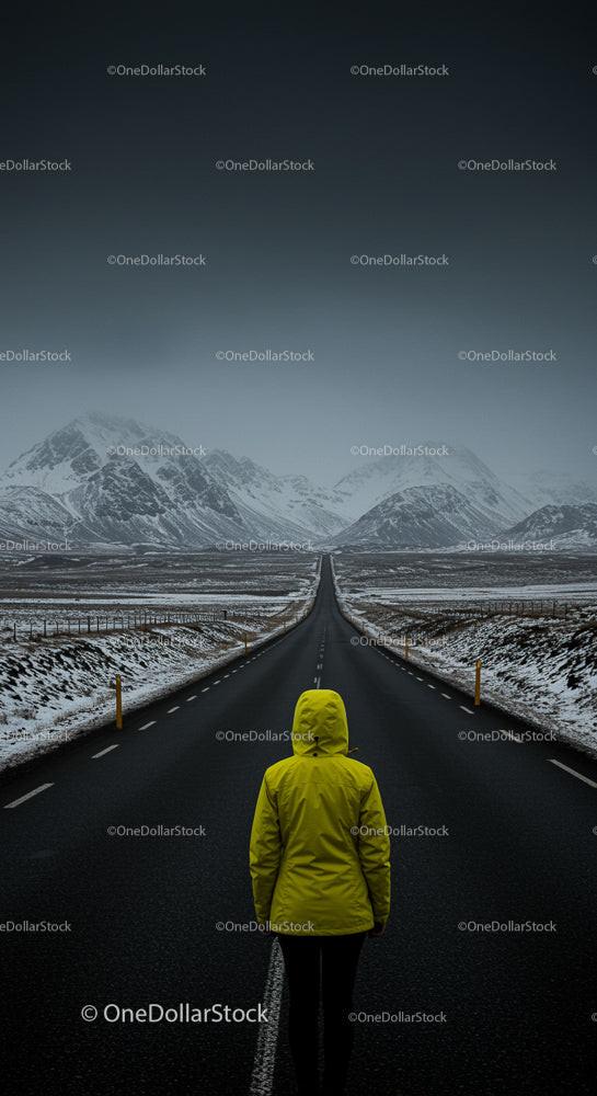 Solitary Traveler on Snowy Mountain Road in Yellow Jacket