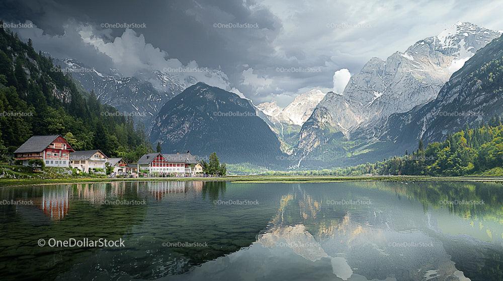 Mountain Village with Serene Lake and Dramatic Clouds