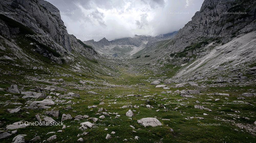 Majestic Mountain Valley with Dramatic Sky and Rugged Terrain