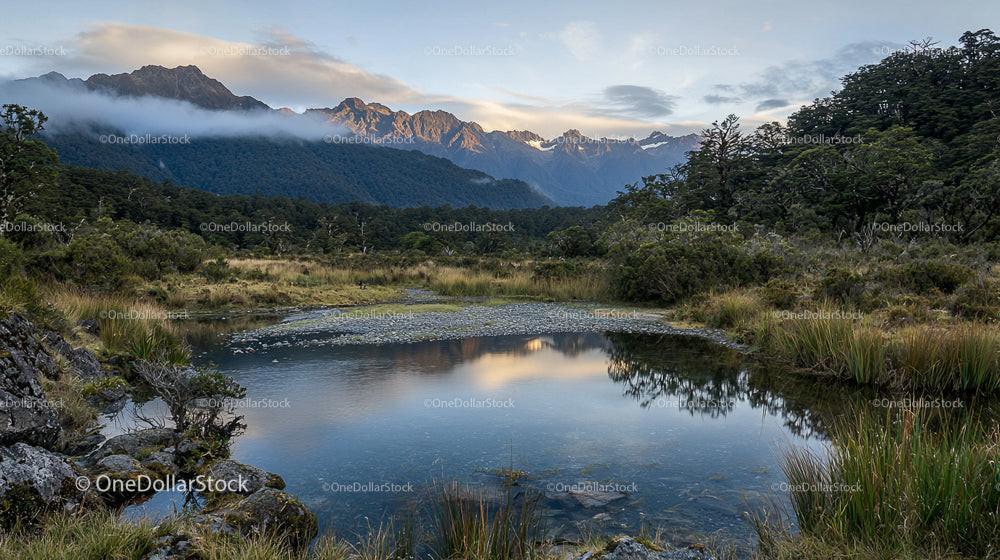 Serene Mountain Landscape with Reflective Pond at Dawn