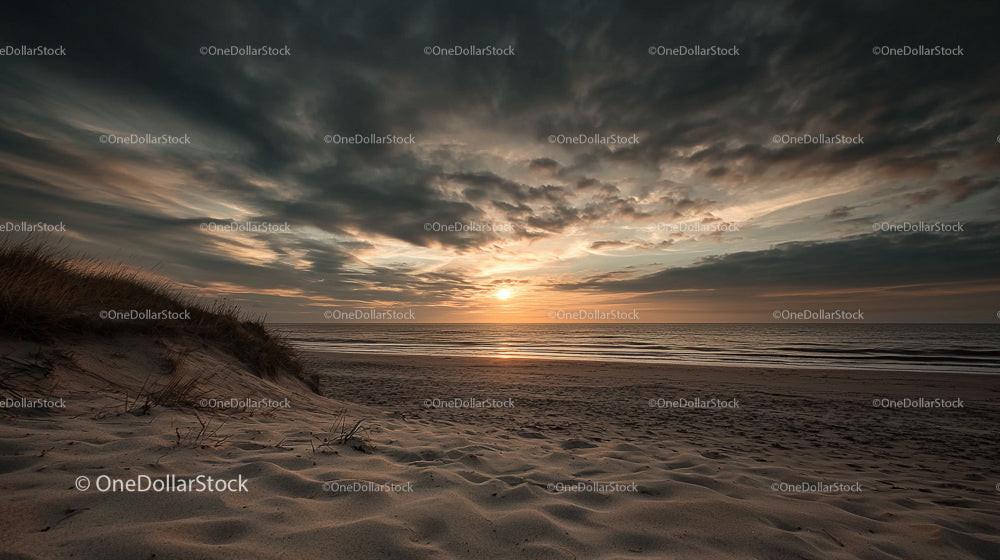 Dramatic Sunset Over Tranquil Ocean and Sand Dunes