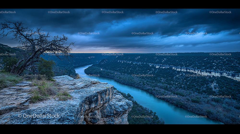 Majestic River Bend Under Dramatic Cloudy Skies