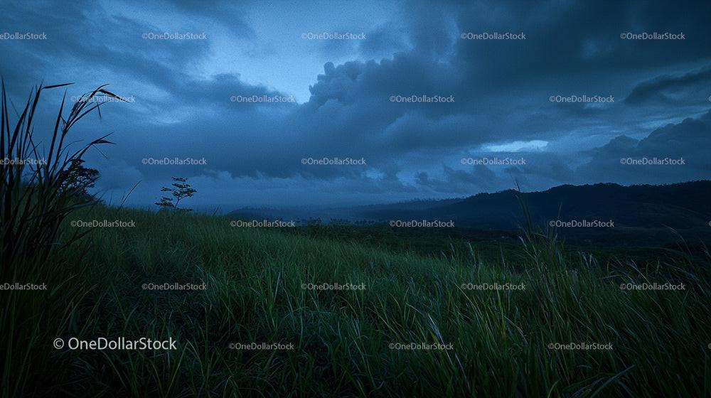 Moody Twilight Over Rolling Hills and Grass Field