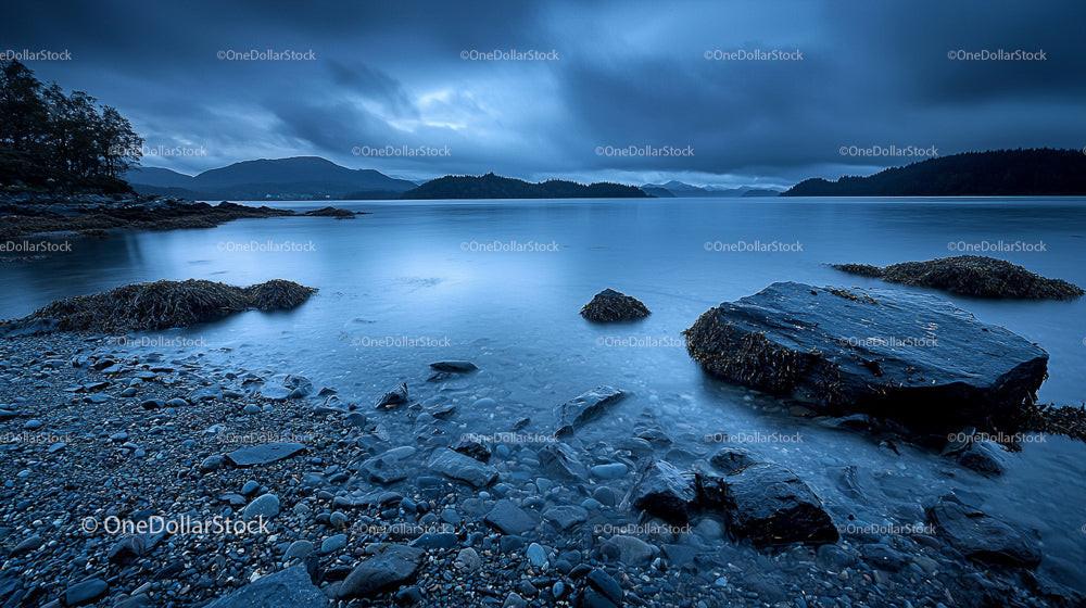 Tranquil Rocky Shoreline and Overcast Skies at Dusk