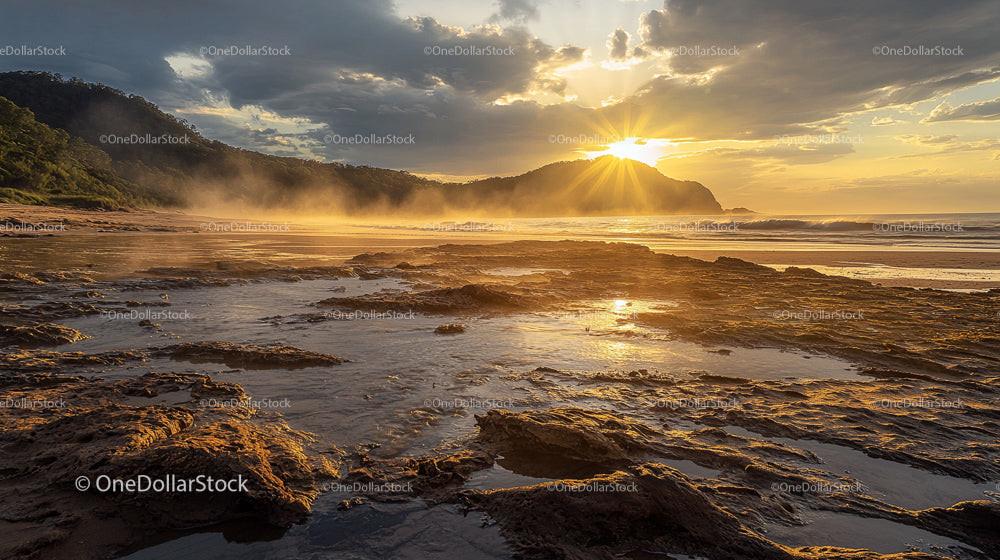 Golden Sunrise Over Rocky Beach with Misty Morning Atmosphere