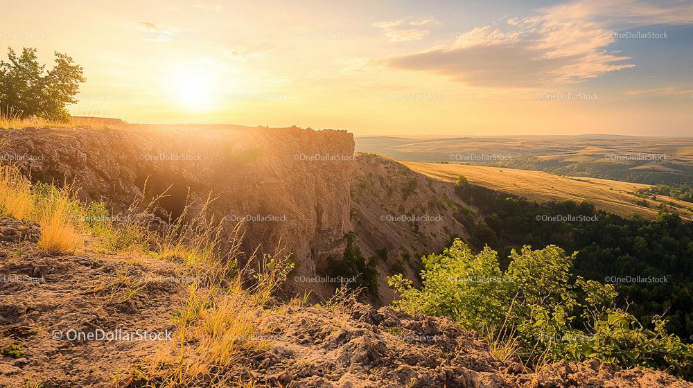 Scenic Sunset Over Rocky Cliff and Rolling Hills