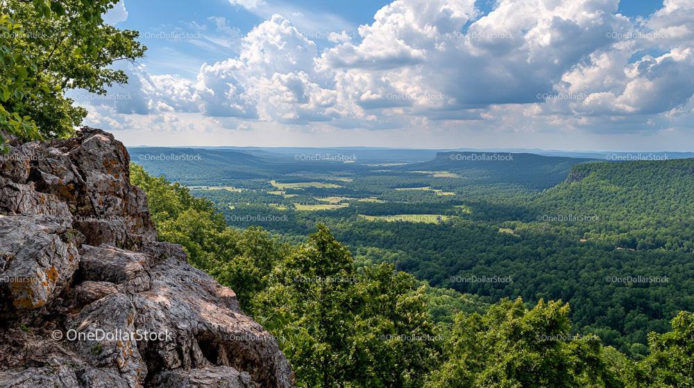 Expansive Mountain View Over Lush Green Valley and Forest