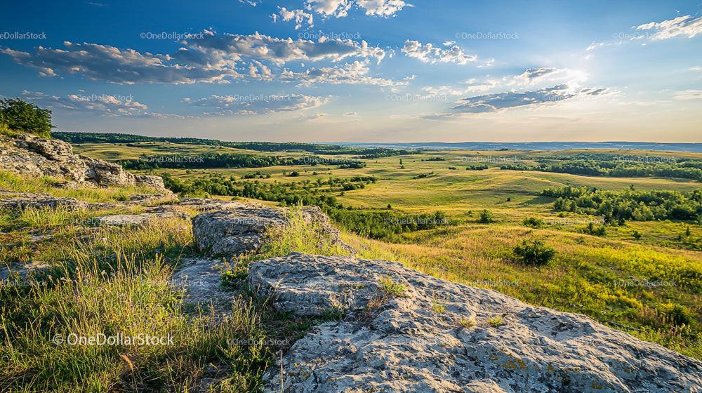 Scenic Rolling Hills and Expansive Fields at Sunset