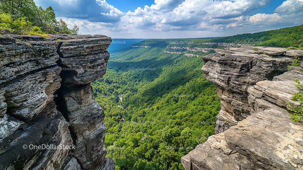 Majestic Cliff Overlooking Verdant Valley and Dramatic Sky