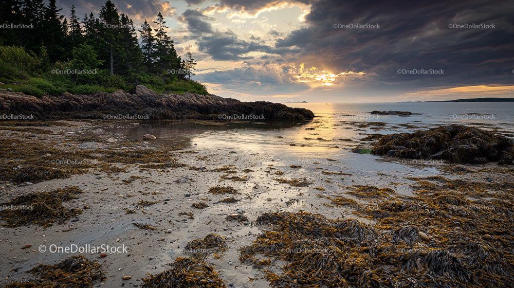 Dramatic Sunset over a Rocky Coastal Shoreline at Twilight