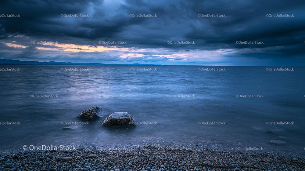 Dramatic Stormy Seascape with Rocky Shore at Dusk