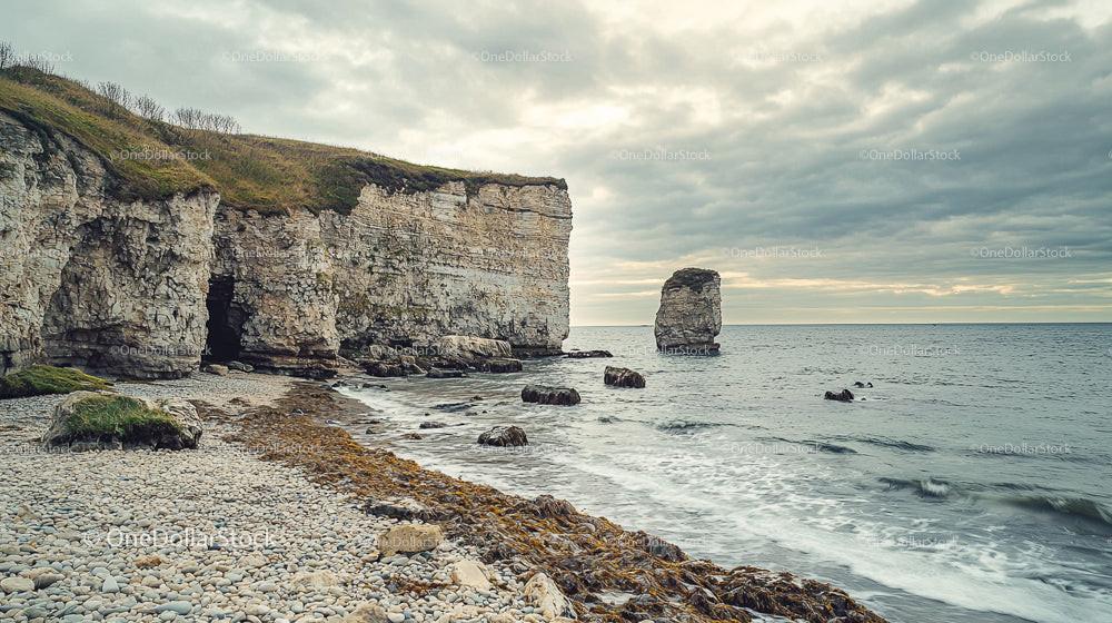 Dramatic Coastal Cliffs with Sea Stack and Overcast Sky