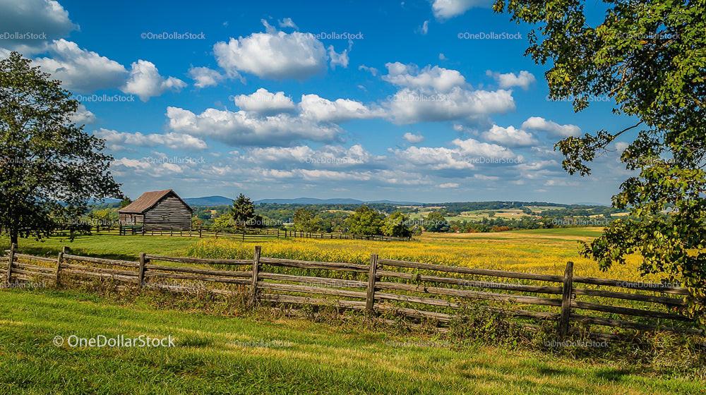 Rustic Barn in Serene Countryside Landscape on Sunny Day
