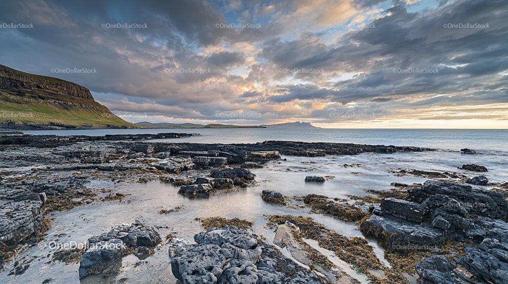 Dramatic Coastal Sunset Over Rocky Shoreline