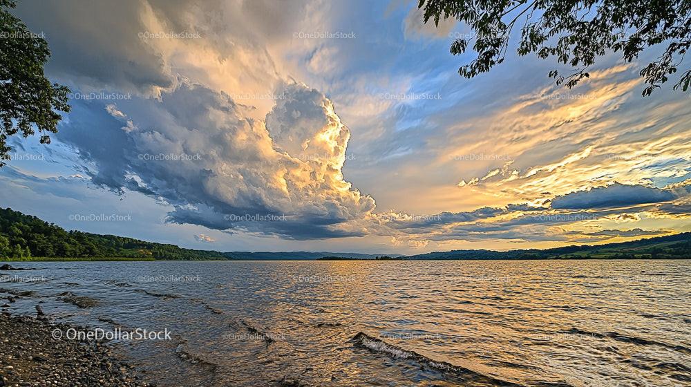 Dramatic Cloudy Sunset Over Tranquil Lake Landscape