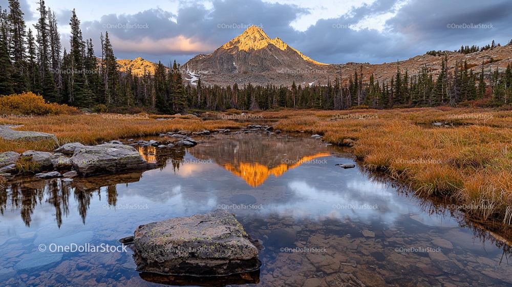 Golden Mountain Peak Reflecting in Tranquil Alpine Lake