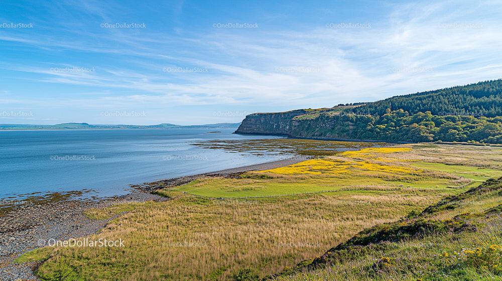 Scenic Coastal View with Blue Ocean and Green Hills