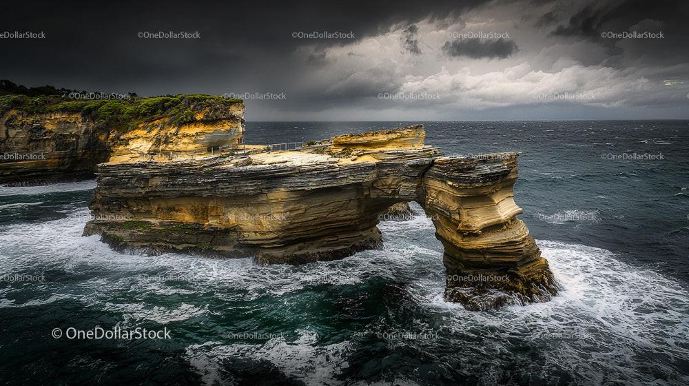 Dramatic Coastal Arch with Stormy Ocean Waves