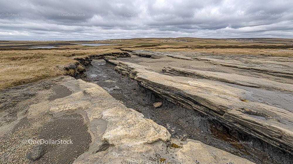 Eroded Rocky Landscape Under Dramatic Overcast Sky