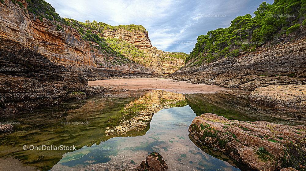 Tranquil Cove with Reflective Waters and Verdant Cliffs