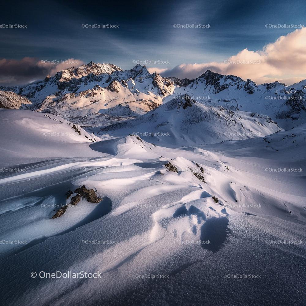Snowy Mountain Peaks Under a Dramatic Sky