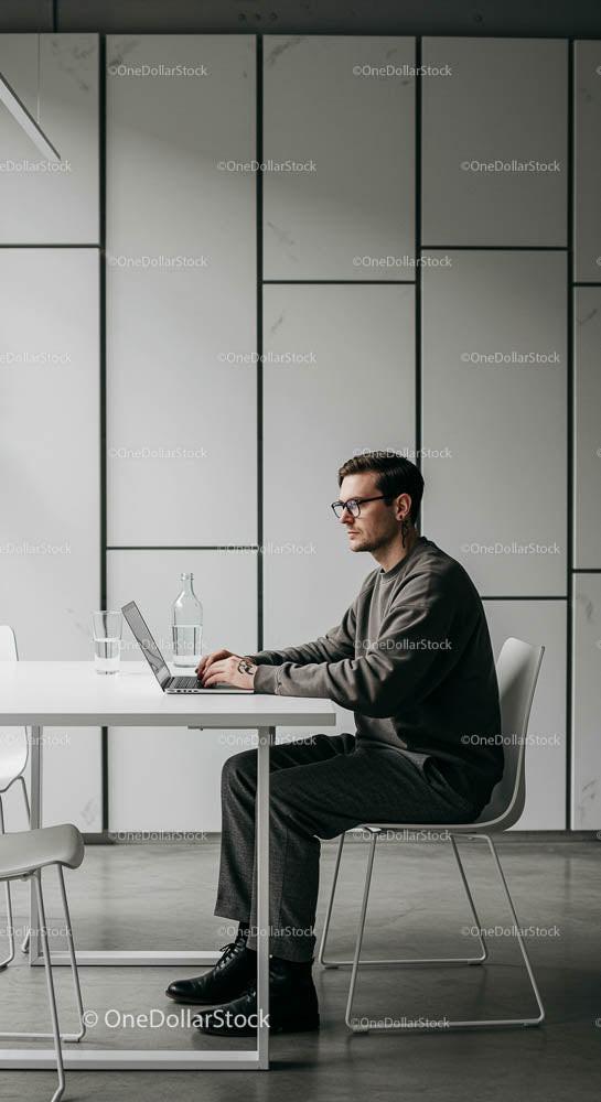 Professional Man Working on Laptop in Modern Office