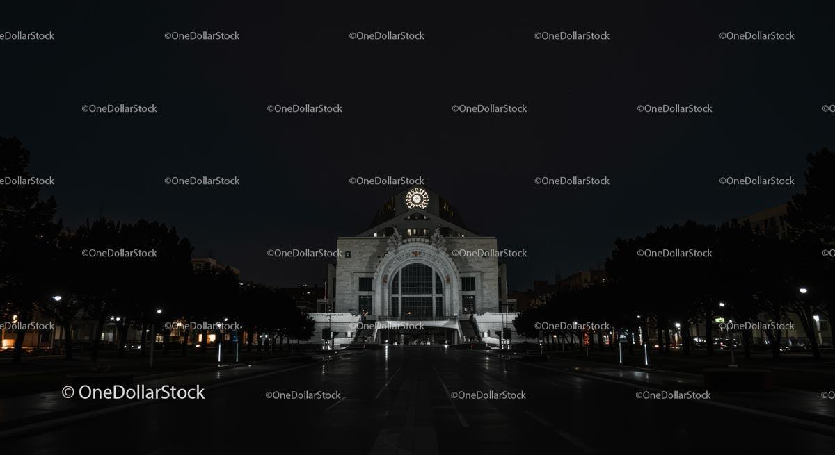 Illuminated Historic Building at Night with Clock Tower