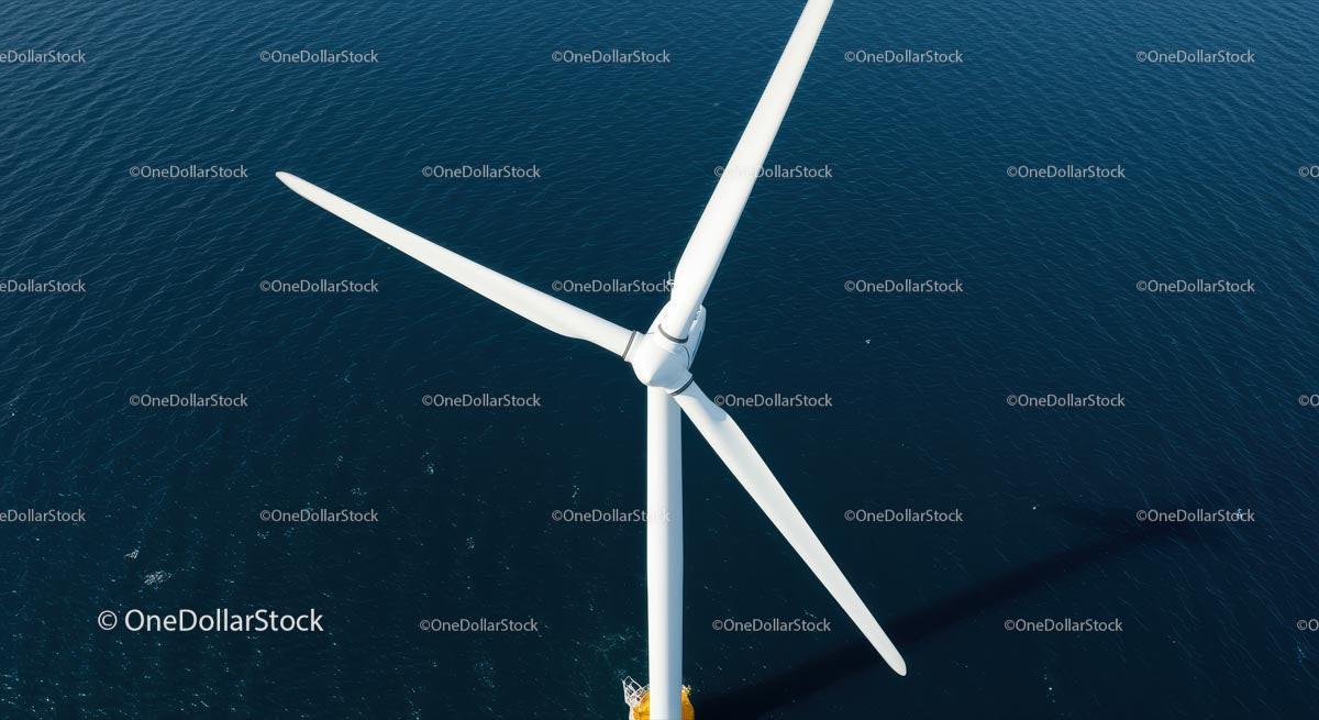 Aerial View of Offshore Wind Turbine Against Deep Blue Sea