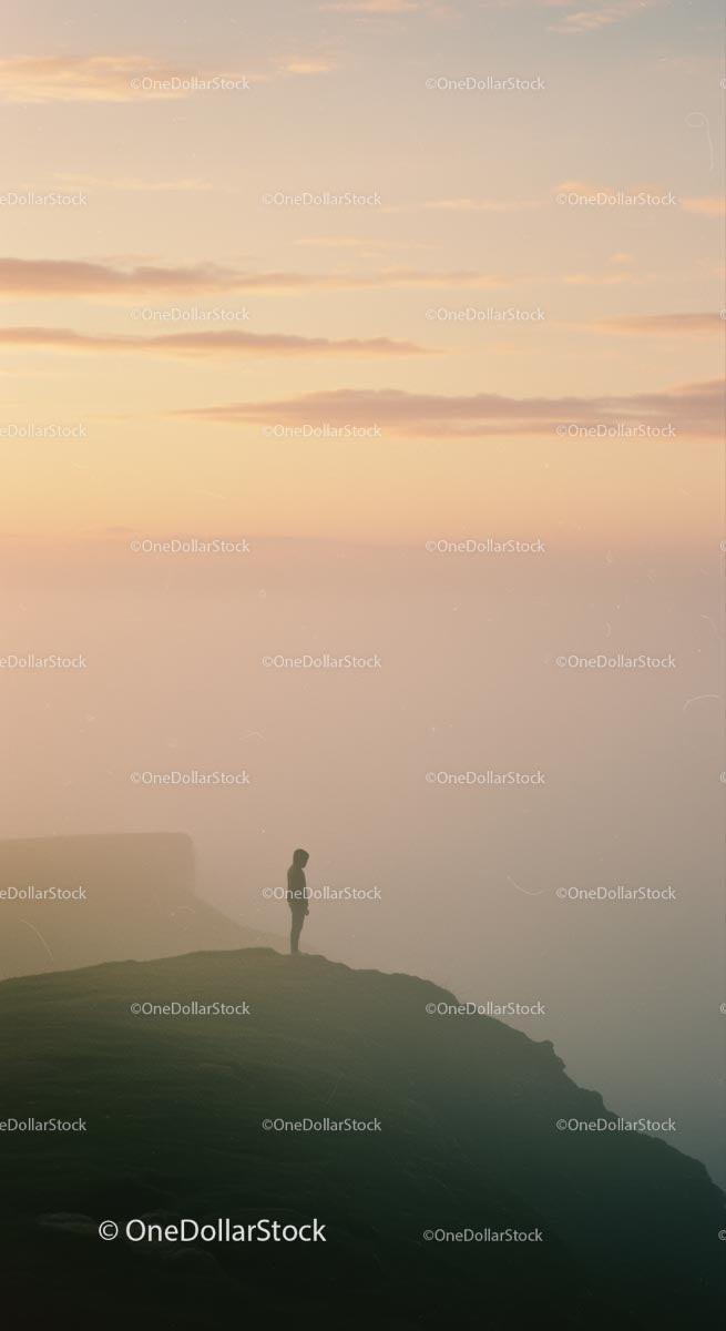Solitary Silhouette on Foggy Cliff at Sunrise