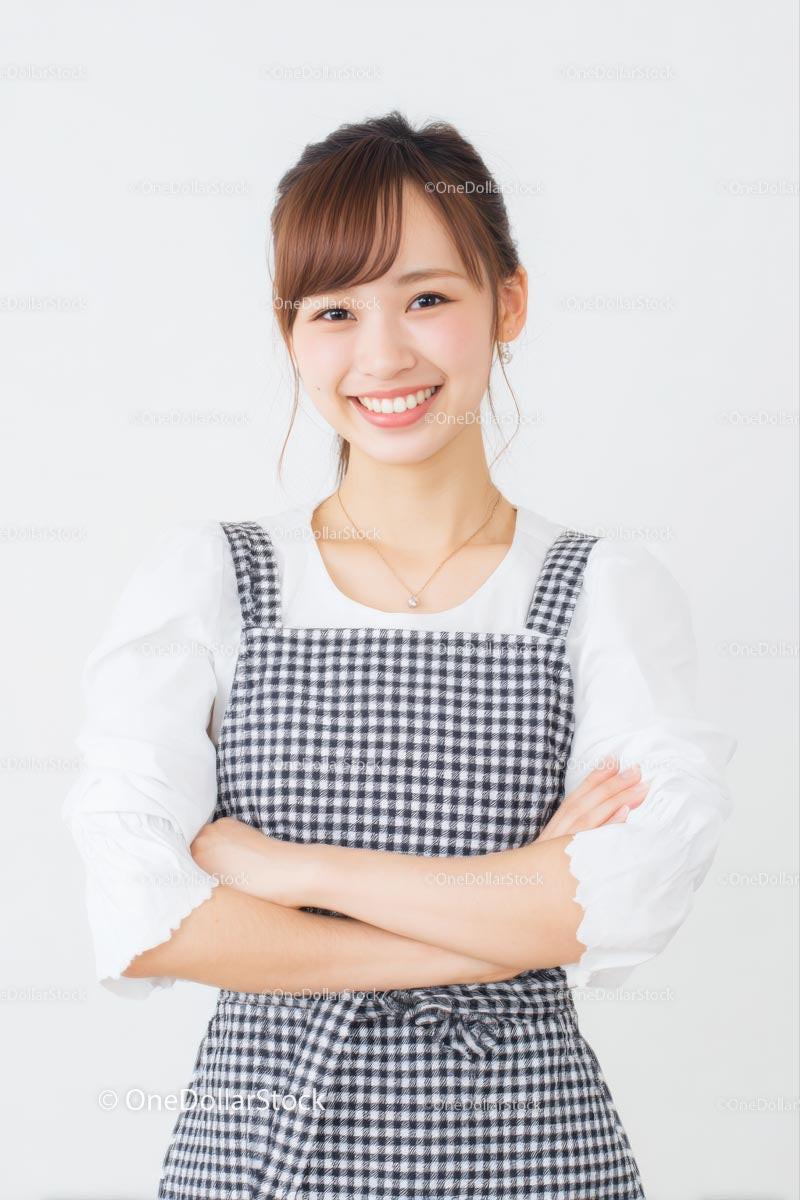 Smiling Woman in Gingham Dress with Arms Crossed