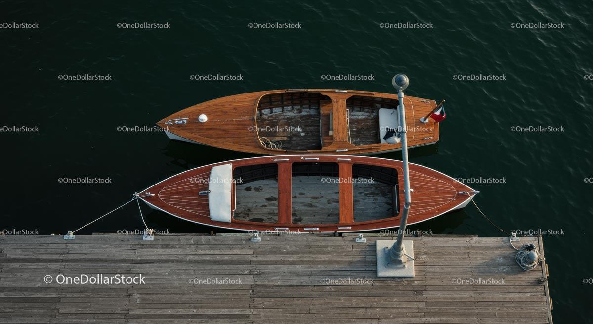 Pair of Wooden Boats Moored at a Dock in Tranquil Marina
