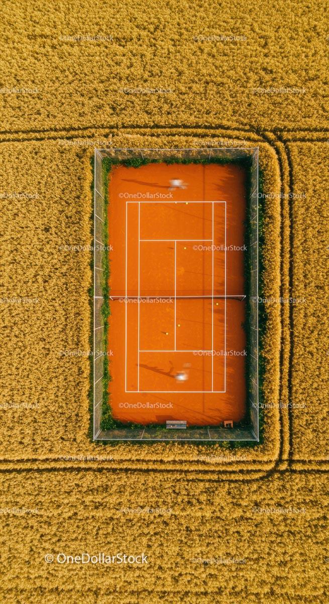 Aerial View of Tennis Court in Expansive Wheat Field