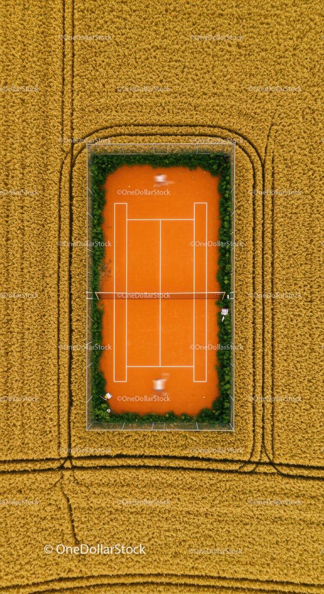 Aerial View of Tennis Court Amidst Golden Wheat Fields