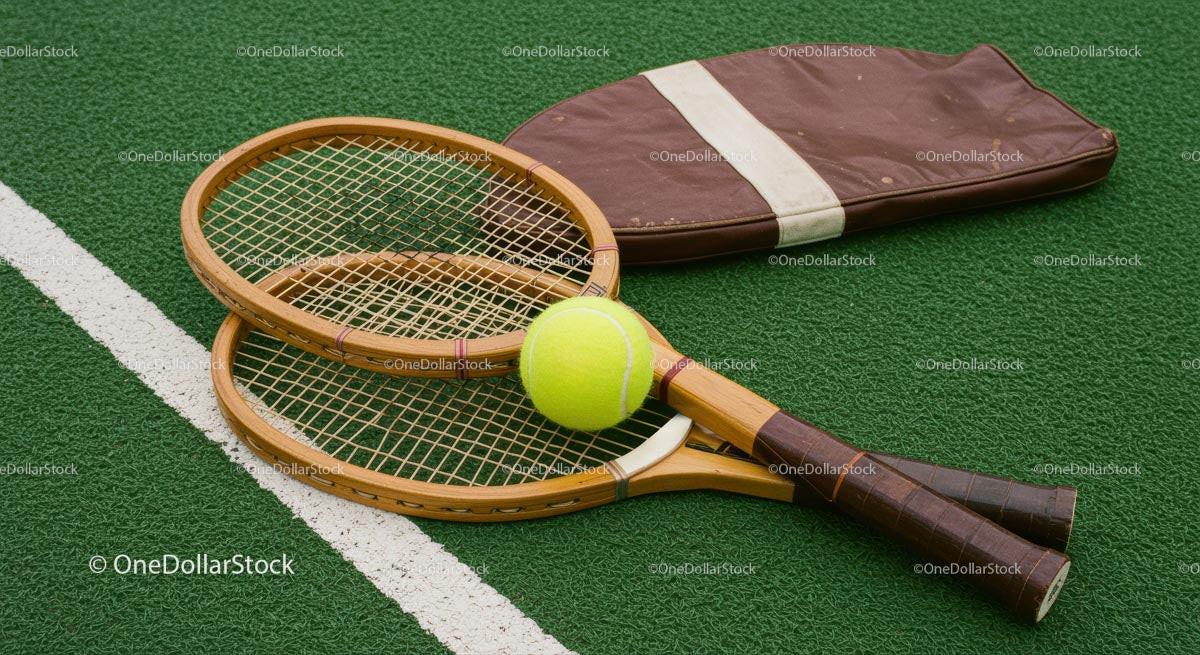 Vintage Wooden Tennis Rackets on Green Court