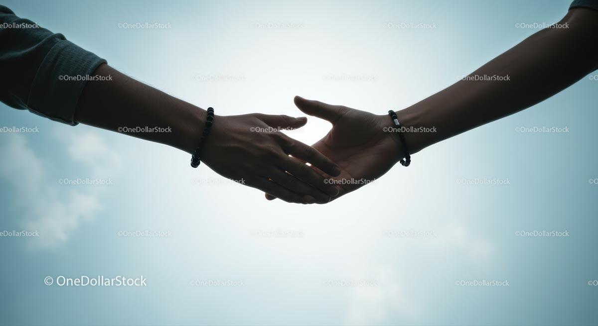 Silhouetted Hands Reaching Out in Unity and Connection