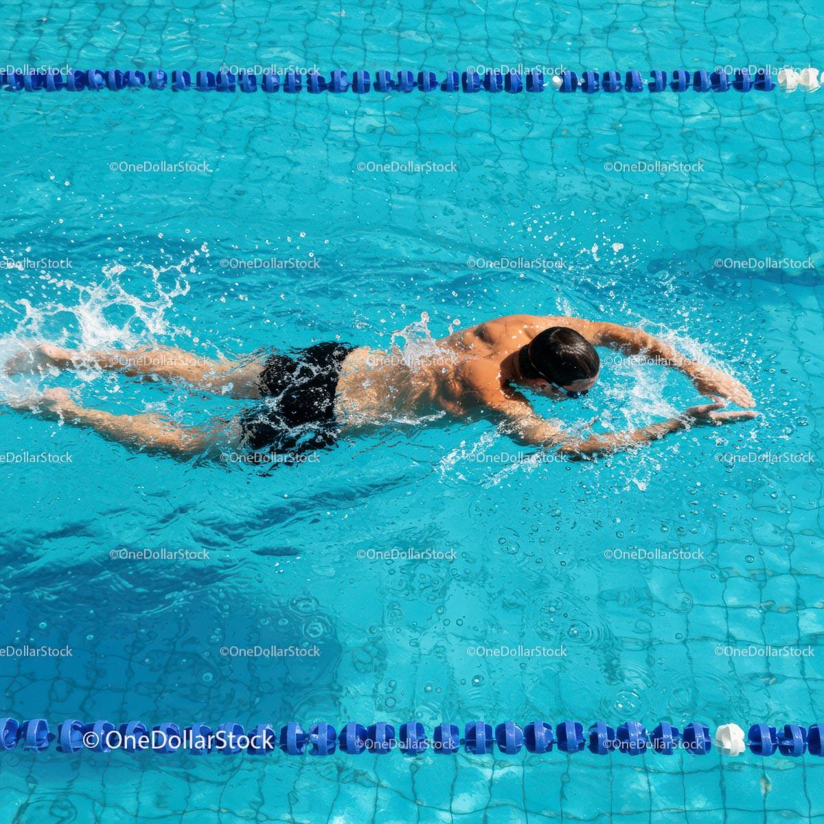 Athlete Swimming Freestyle in Outdoor Pool