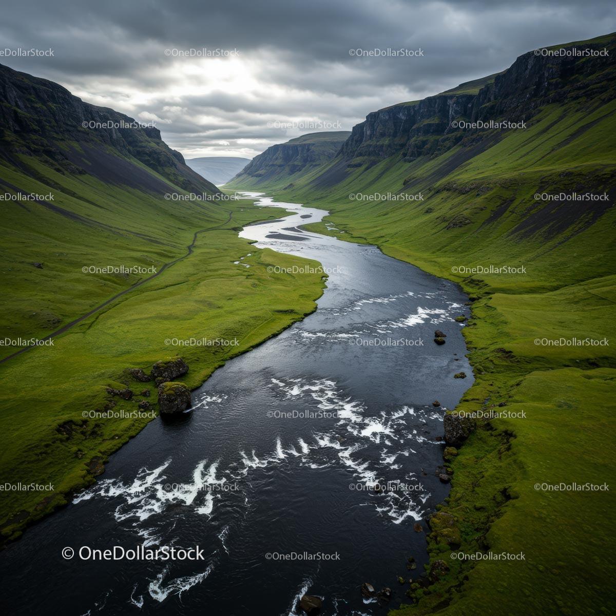 Dramatic River Cutting Through a Green Valley Under Cloudy Skies