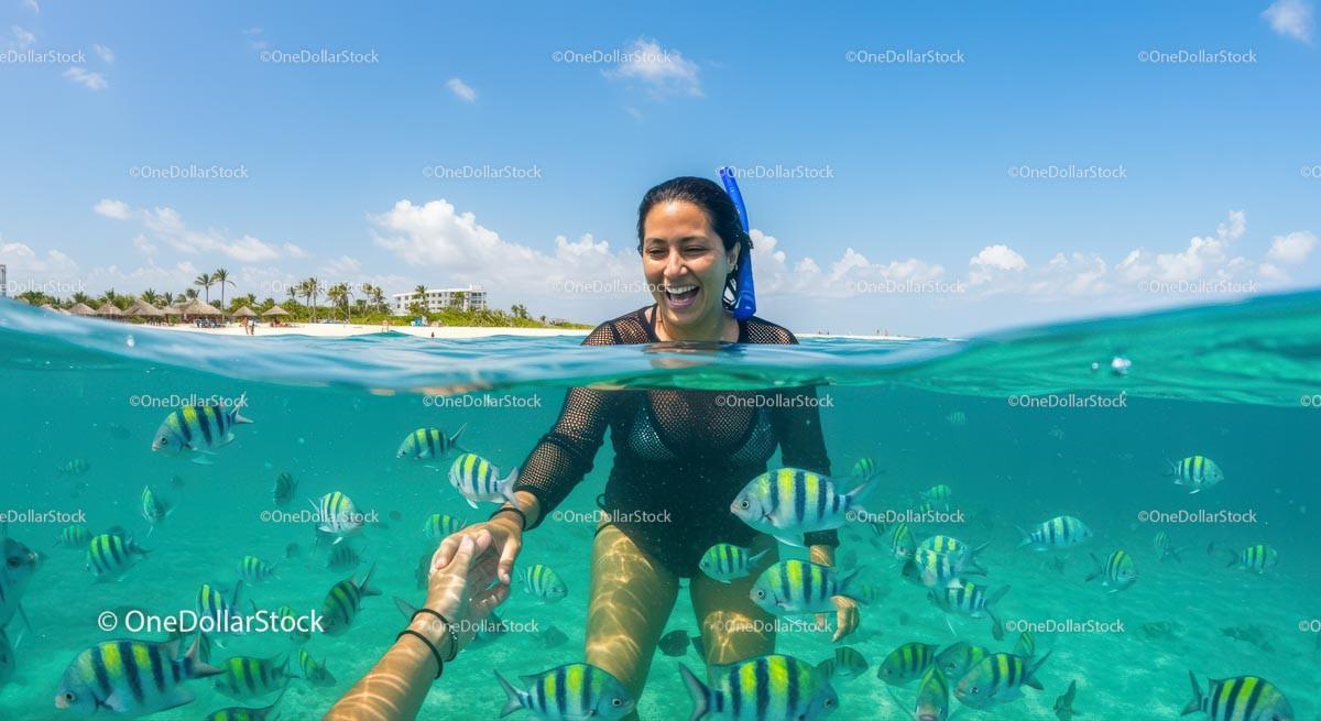Woman Snorkeling Amidst Colorful Tropical Fish in Clear Water