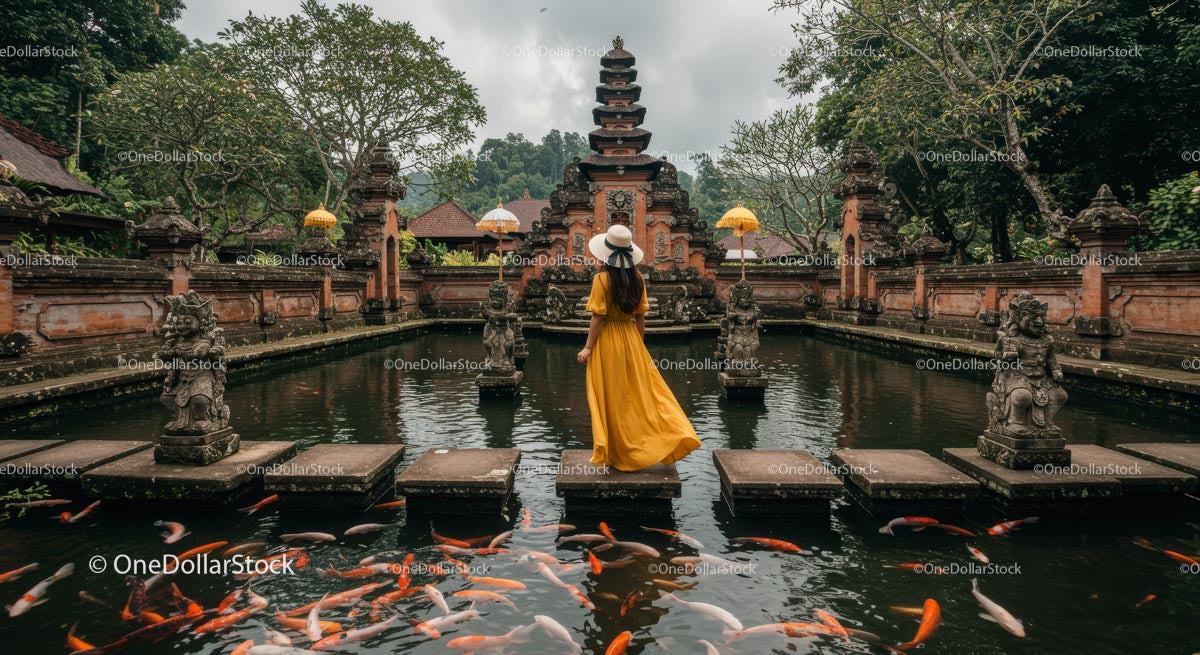 Woman in Yellow Dress at Balinese Temple Pond