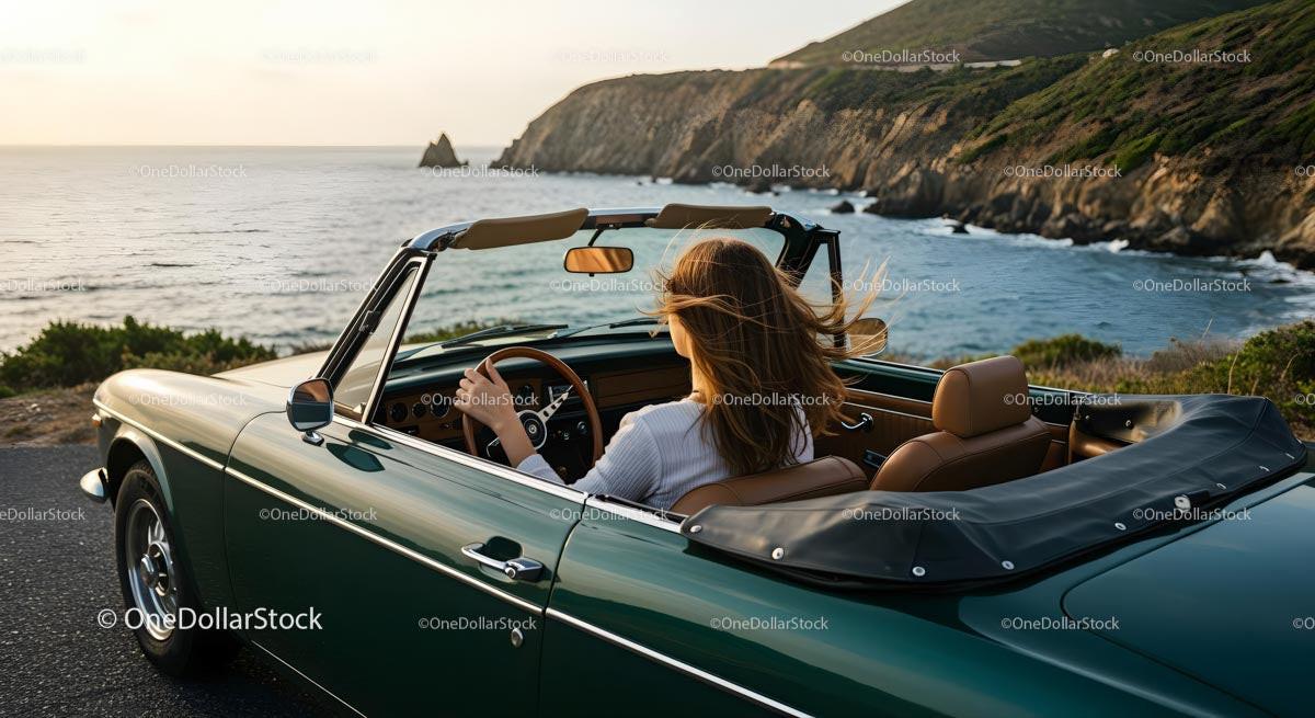 Woman Driving Vintage Convertible Along Scenic Coastal Road
