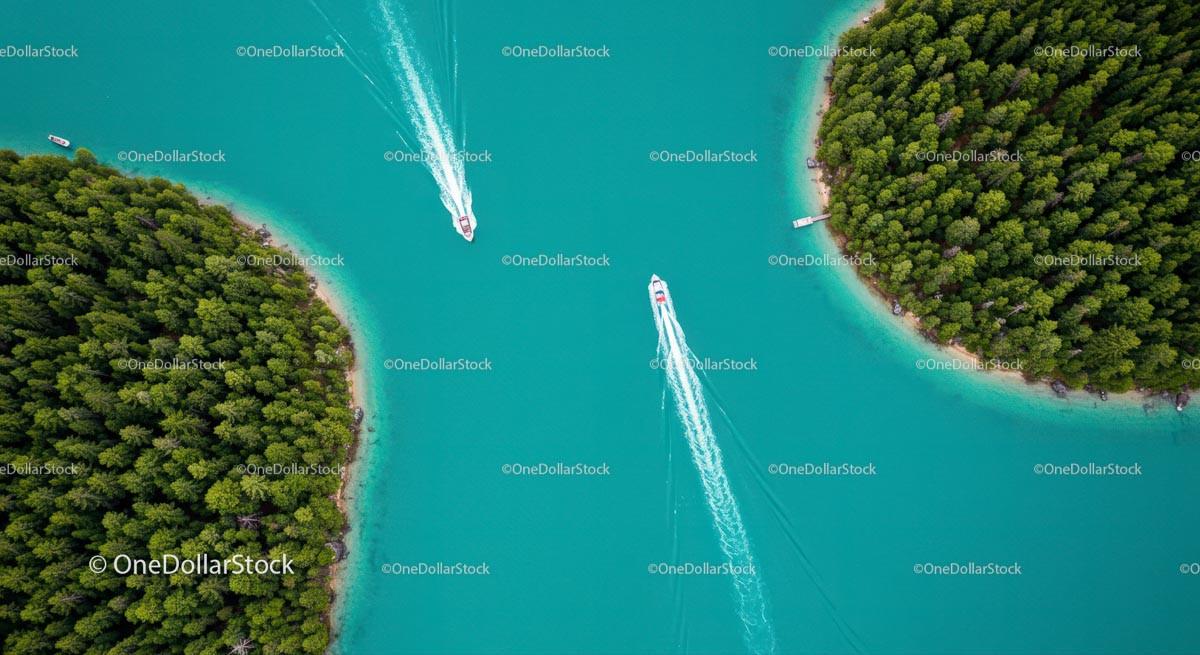 Aerial View of Turquoise Lake with Speedboats and Pine Forest