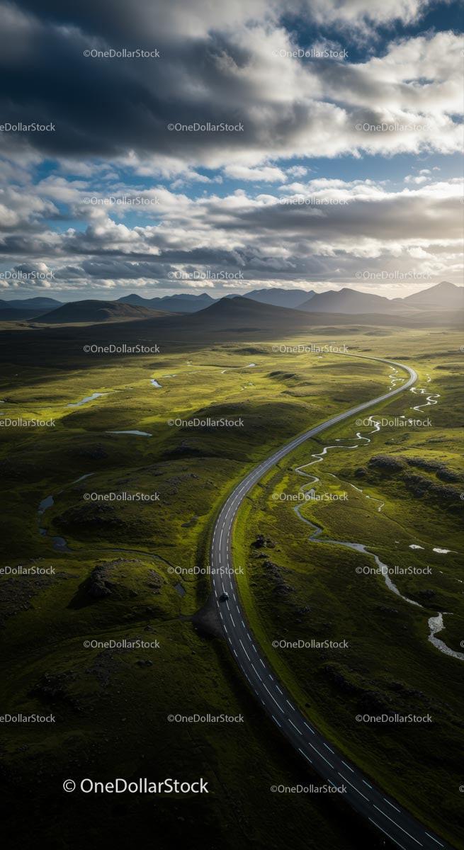 Scenic Road Through Lush Green Highlands Under Dramatic Sky