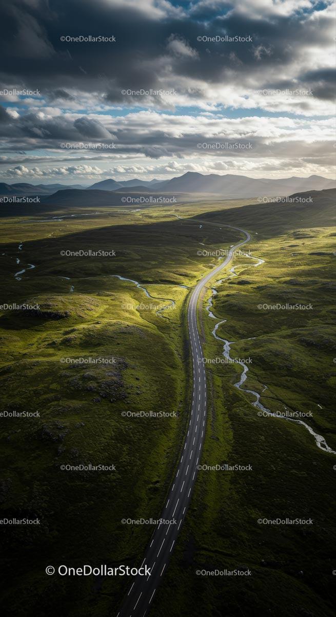 Winding Road through Vast Green Plains under Dramatic Clouds
