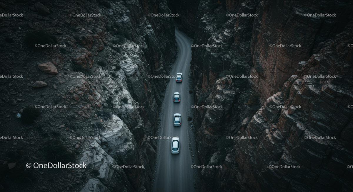 Aerial View of Cars Navigating a Narrow Canyon Road