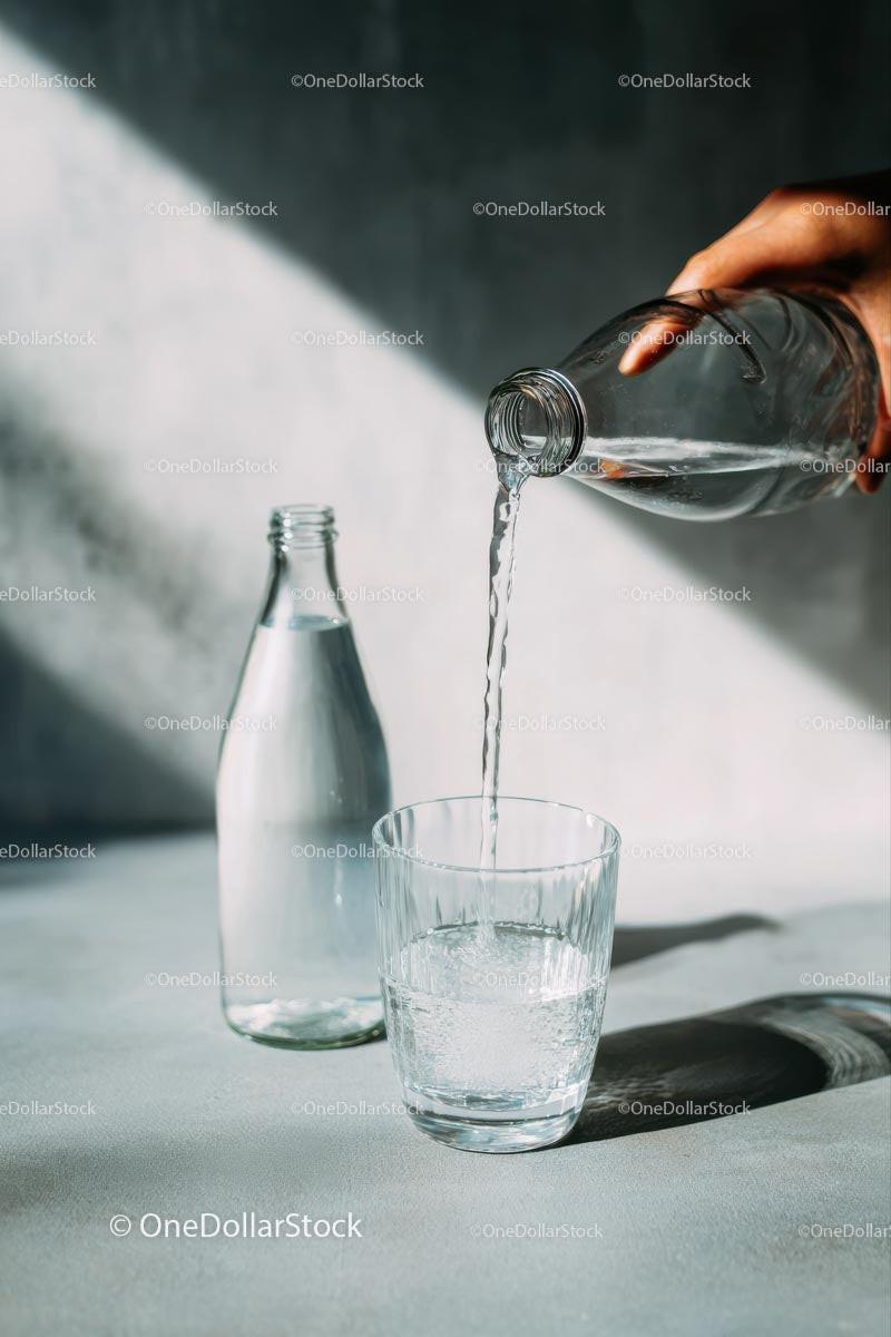 Pouring Water into a Glass with Sunlit Reflections Stock Photo Bundle preview 10