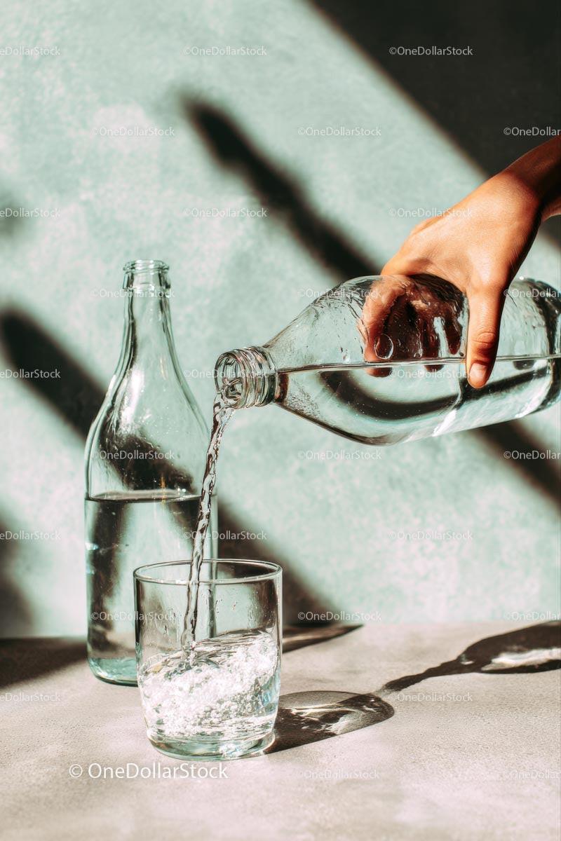 Pouring Water into a Glass with Sunlit Reflections Stock Photo Bundle preview 19