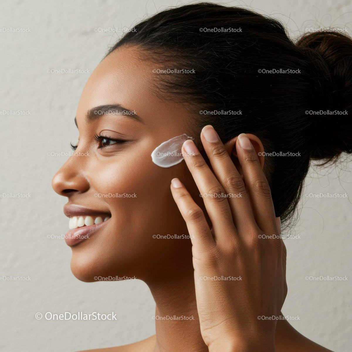 Beautiful Woman Applying Skincare Cream on Cheek in Close-Up