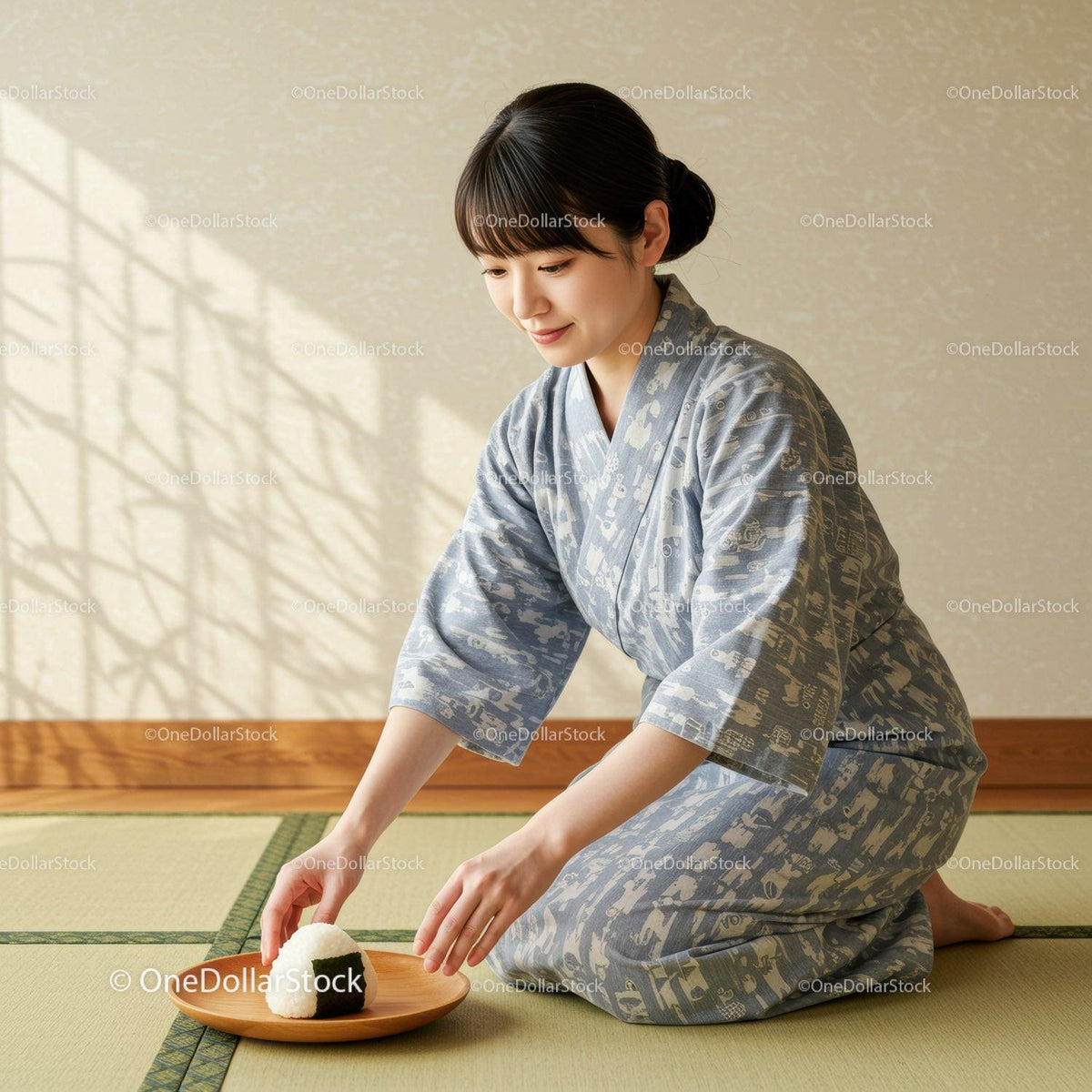 Young woman in kimono placing rice ball on wooden plate