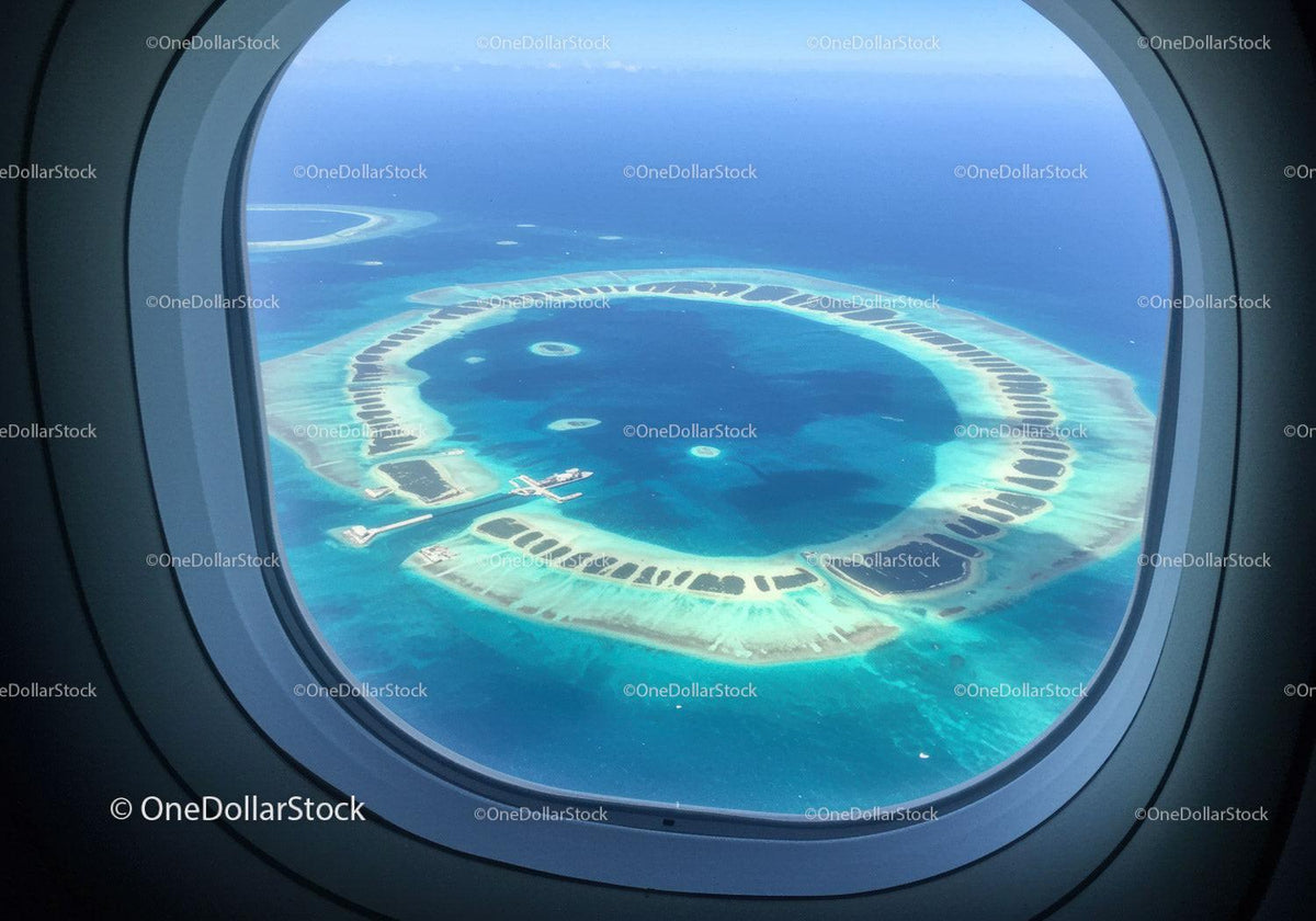 Aerial View of Circular Coral Atolls in Clear Blue Ocean